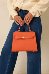 Reign It In Orange Faux Leather Twist Lock Handbag