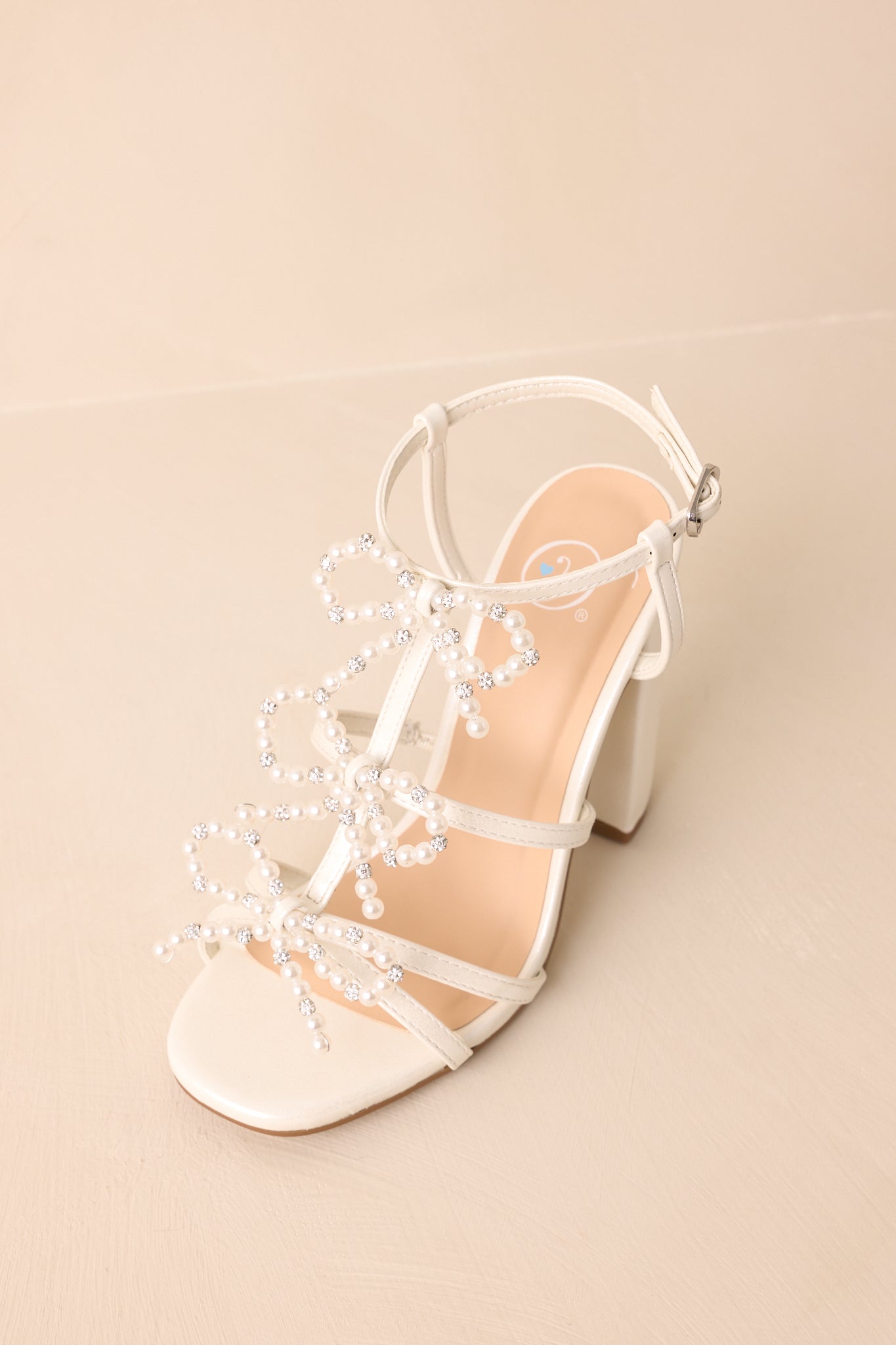Reaching Higher Ivory Pearl Bow Front Ankle Strap Heels